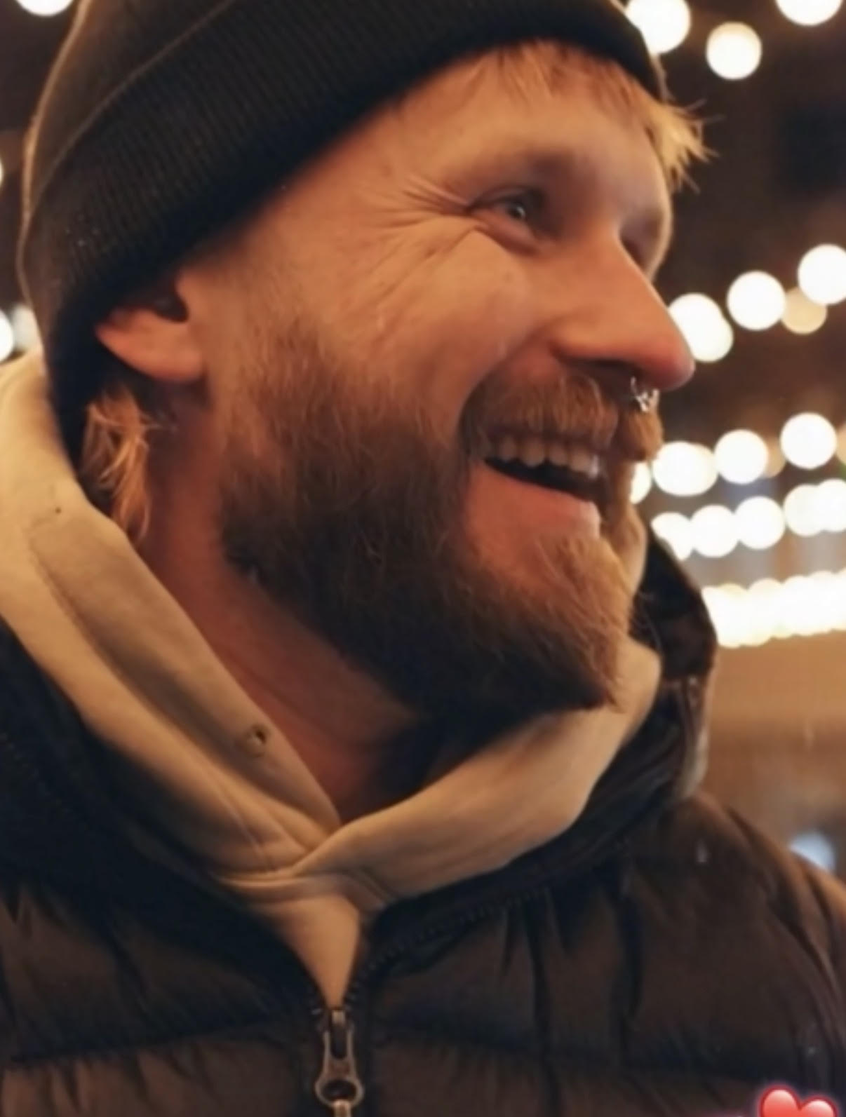 Brian Brady smiling under string lights